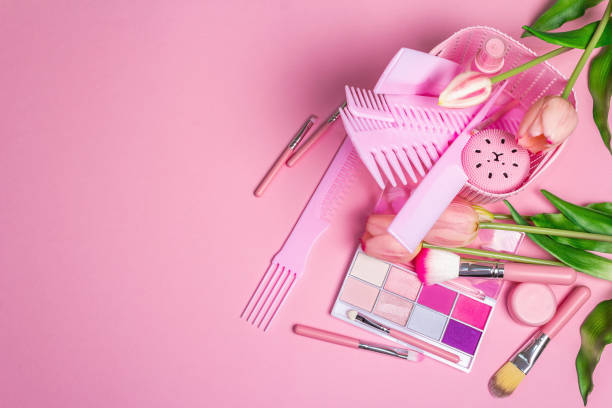 istock Makeup cosmetic set and hair combs on pink background 1307731350