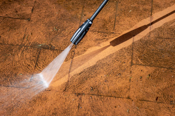 istock Cleaning backyard paving tiles with pressure washer. 1307731409
