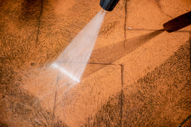 istock Cleaning backyard paving tiles with pressure washer. 1307731414
