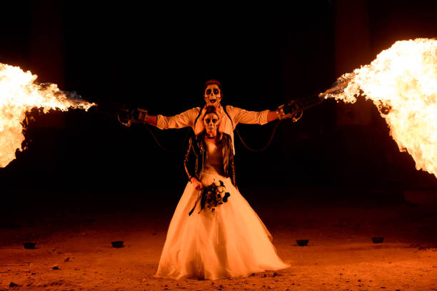 istock Halloween couple standing with flamethrower. big fire 1307731589