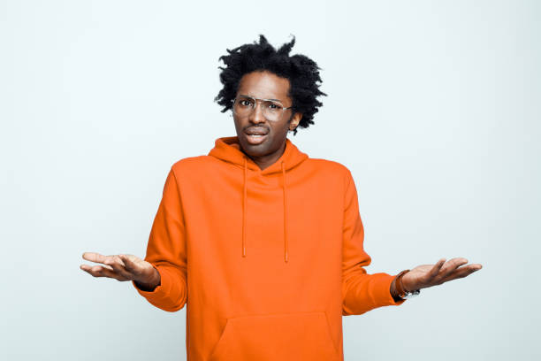 istock Confused man in orange hoodie 1307732374