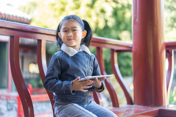 istock Little girl holding tablet computer 1307732387