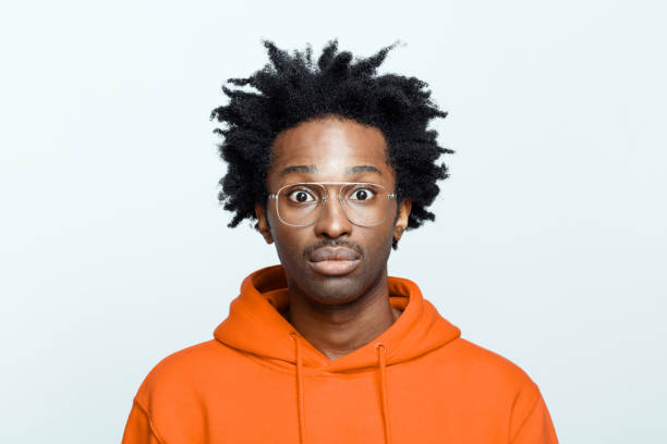 istock Confused man in orange hoodie 1307732434