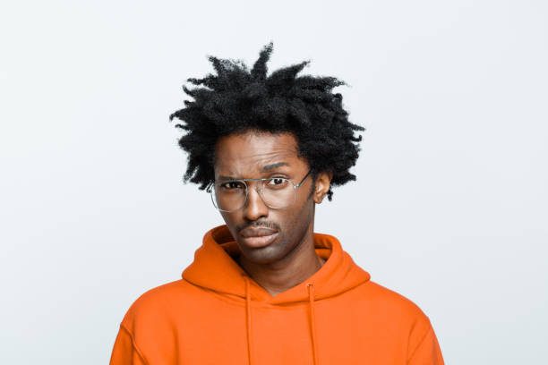 istock Confused man in orange hoodie 1307733013