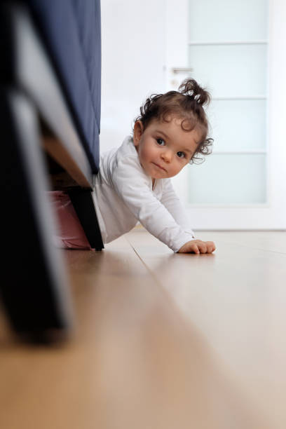 istock Baby girl crawling at home 1307733581
