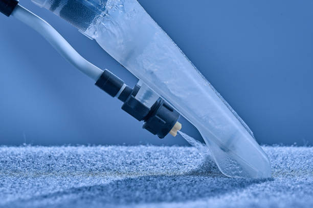 istock Washing carpet with vacuum cleaner close-up on a blue background. 1307733696