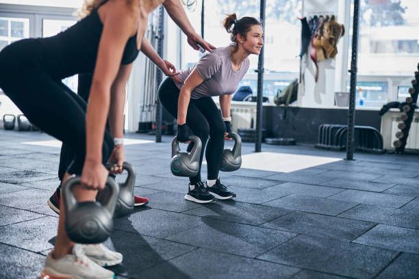 istock Two young females working out with kettlebells 1307733977