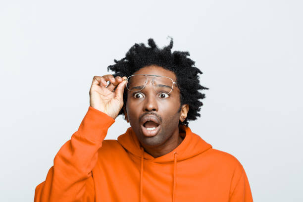 istock Shocked man in orange hoodie 1307733992