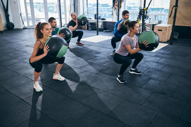 istock Five athletes exercising with stability balls indoors 1307734053