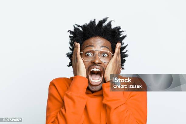 Shocked Man In Orange Hoodie Stock Photo - Download Image Now - Shock, Bad News, Human Face