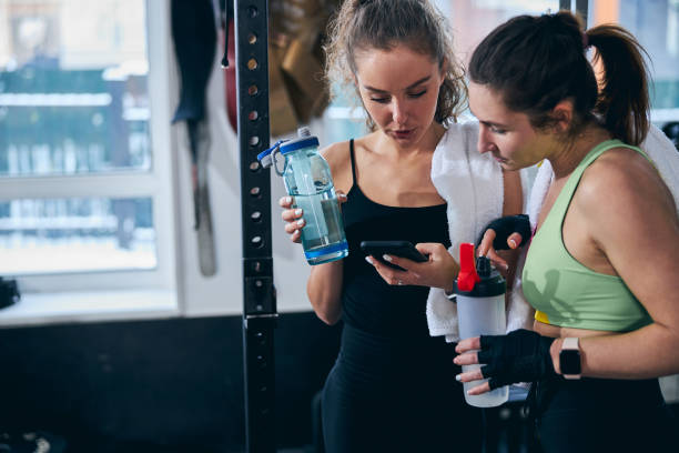 istock Two concentrated female athletes surfing the net after the workout 1307734068