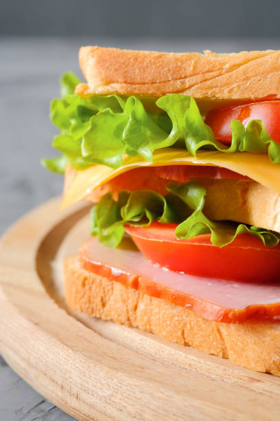 istock Tasty sandwich on gray background closeup 1307734088