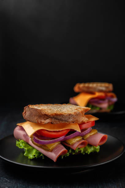 istock Sandwich with ham, tomatoes, lettuce and yellow cheese 1307734199