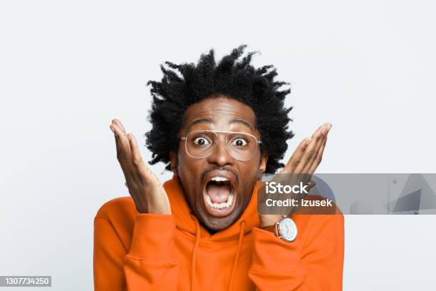 Terrified Man In Orange Hoodie Stock Photo - Download Image Now - Fear, Human Face, Men