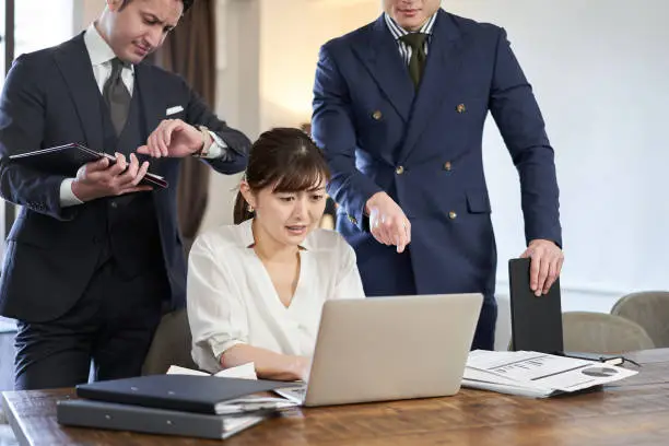 Photo of Asian business woman driven by work