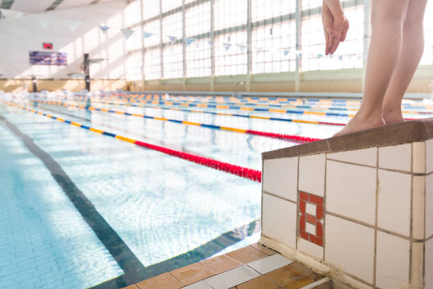 cute little kid boy having rest after swimming in the sport swimming pool. training for competition. sport activities for children. - swimming child swimwear little boys imagens e fotografias de stock