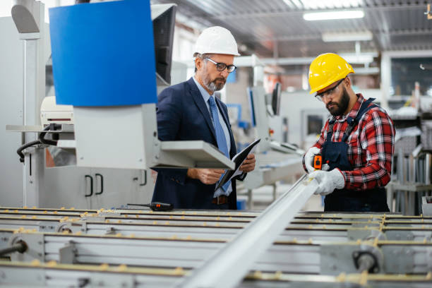 istock Young engineer with quality control inspector in factory stock photo 1307737140