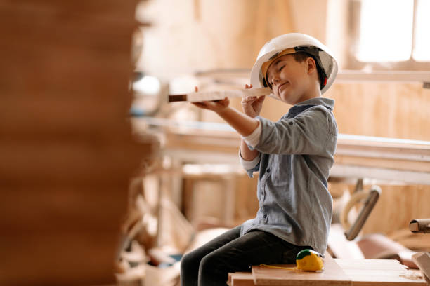 istock Boy builds a toy of wood 1307738423