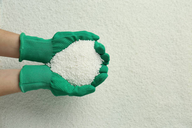 Woman holding pile of granular mineral fertilizer over grains, top view. Space for text Woman holding pile of granular mineral fertilizer over grains, top view. Space for text salt mineral photos stock pictures, royalty-free photos & images