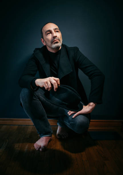 Atmospheric studio portrait of a mature man