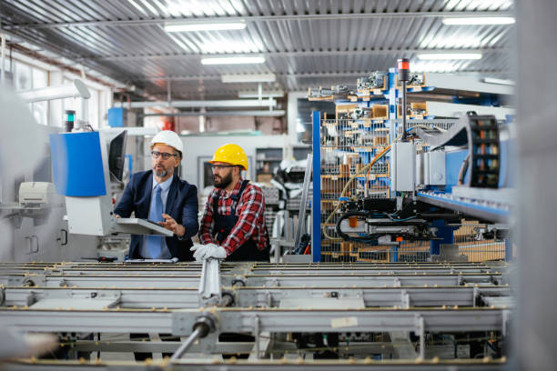 istock Quality inspector and manual worker in a factory 1307739716