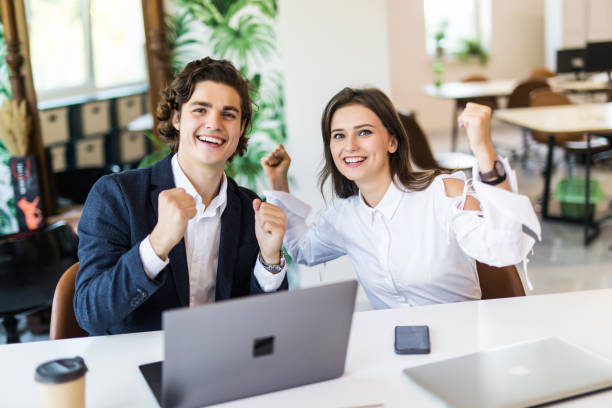 istock We won. Cheerful young people looking excited while sitting at the office table at the business meeting 1307739972