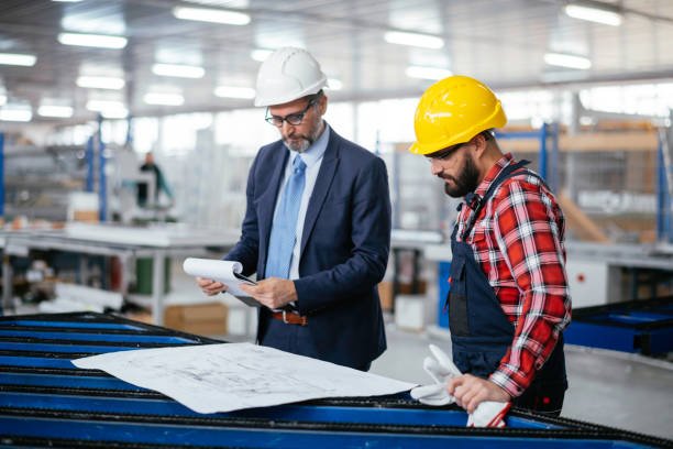 istock Young engineer with quality control inspector in factory stock photo 1307740788