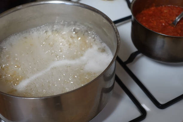 istock Spaghetti and bolognese sauce being cooked in saucepans 1307740806