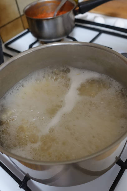 istock Spaghetti and bolognese sauce being cooked in saucepans 1307740814
