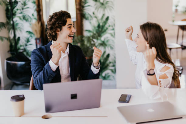istock We won. Cheerful young people looking excited while sitting at the office table at the business meeting 1307741487