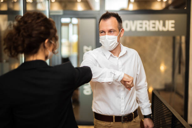istock Two business people greeting during pandemic. 1307742701