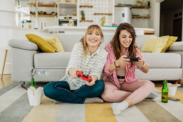 istock Female friends playing video games 1307743563