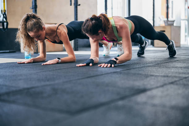 istock Two fit women working their core muscles 1307744817