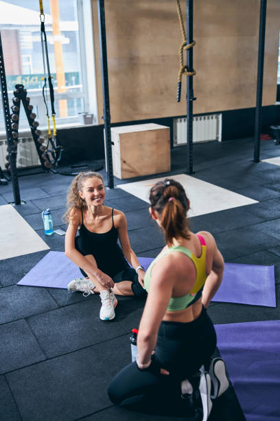 istock Personal trainer talking to her pleased female client 1307744833