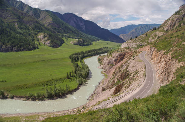 istock Scenic view of empty winding road and raging mountain river. 1307745753