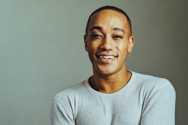 istock Close up studio portrait man smiling showing teeth looking at camera 1307745790