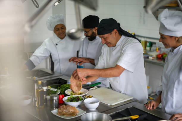 istock Cooks wearing facemasks while cooking at a restaurant during the pandemic 1307746905