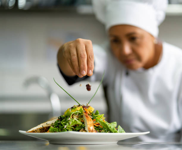 istock Chef working at a restaurant and decorating a plate in the kitchen 1307746938