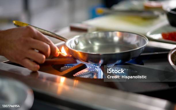Chef Lighting Up A Gas Stove Burner With A Match Stock Photo - Download Image Now - Gas, Natural Gas, Stove