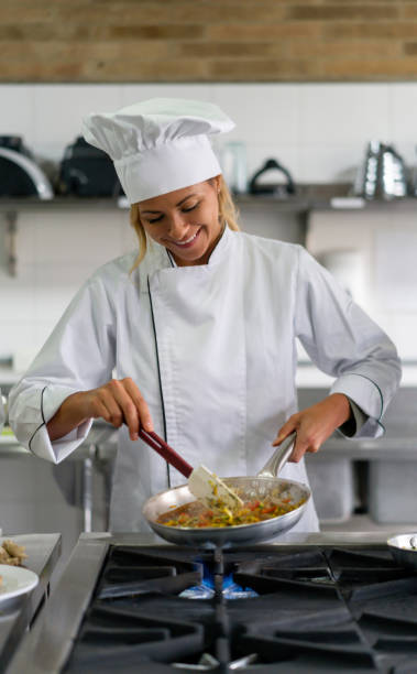 istock Happy chef cooking in a commercial kitchen 1307746956