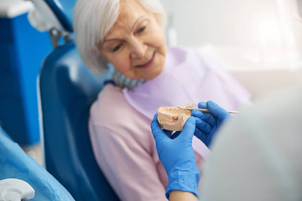 istock Orthodontist touching tooth on plaster teeth model with dental probe 1307747037