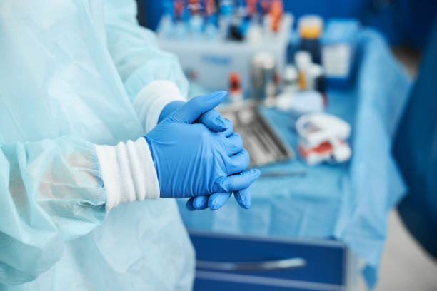 istock Medic joining hands together near instrument table 1307747057