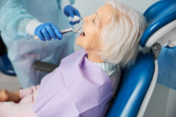 istock Dentist clinic worker providing forcep extraction of patient tooth 1307747065