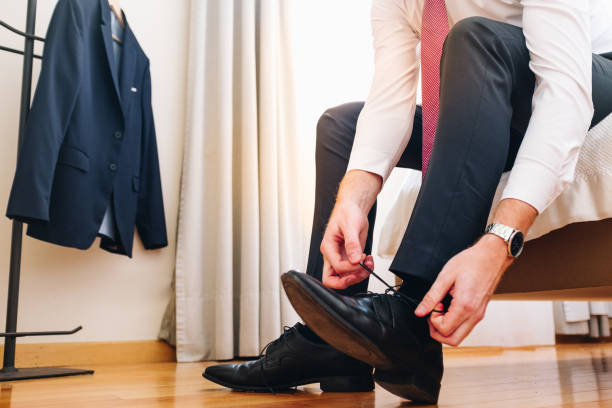 istock Young businessman where are the shoelaces 1307747241