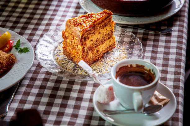 istock Slice of old-fashioned Serbian cake on the table with coffee 1307747302