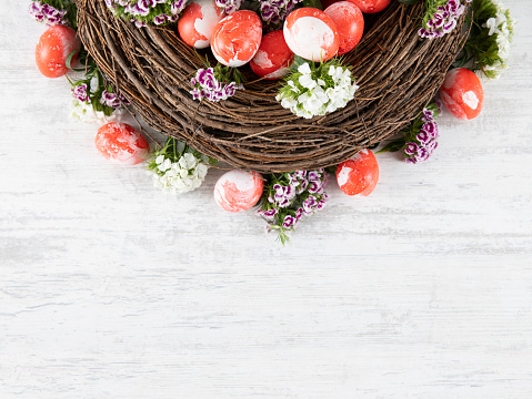 Easter wreath background with dyed eggs