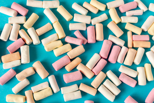istock Colorful marshmallows on a blue background. Close-up. Selective focus. 1307748344