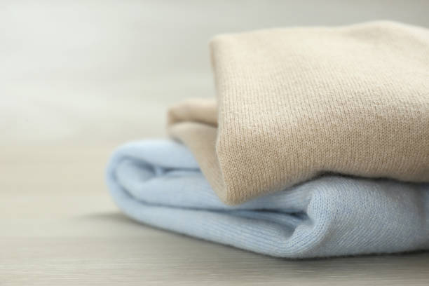 istock Cashmere clothes on wooden table, closeup view 1307748503