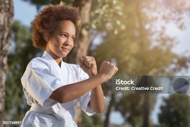Cute Afro American Girl Practicing Martial Arts On Sunny Day In Park Stock Photo - Download Image Now