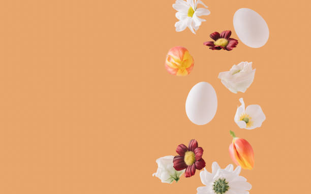istock White daisies, tulips, Easter eggs and various flowers floating on orange background. Minimal, bold springtime composition. 1307750852